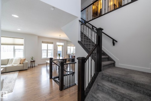 The property features an open-concept living area with hardwood flooring and recessed lighting - 14 Edgewater Terr North, St. Albert, AB - Indoor Photo Showing Other Room