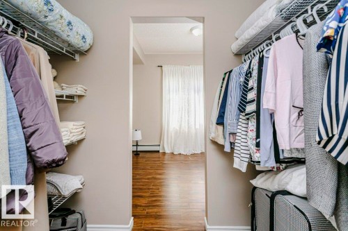 Walk-in closet featuring wire shelving and hanging rods - 323 16807 100 Avenue, Edmonton, AB - Indoor With Storage
