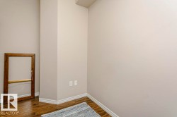 Wood-finish flooring with white baseboards and light-toned walls - 