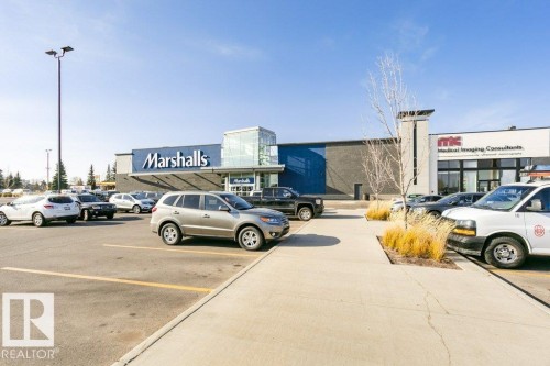 Commercial building featuring a blue and grey facade with prominent storefront branding - 323 16807 100 Avenue, Edmonton, AB - Outdoor