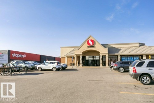 Retail building featuring a central entrance with a gabled roofline and multiple storefronts - 323 16807 100 Avenue, Edmonton, AB - Outdoor