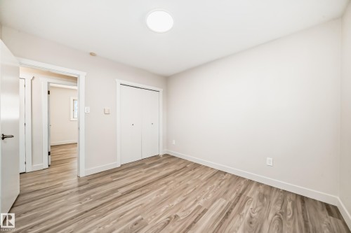 Room featuring wood-finish flooring, white walls, and a flush-mount ceiling light - 13124 83 Street, Edmonton, AB - Indoor Photo Showing Other Room