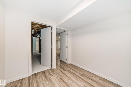 Room featuring wood-finish flooring, white walls, and white trim - 13124 83 Street, Edmonton, AB - Indoor Photo Showing Other Room