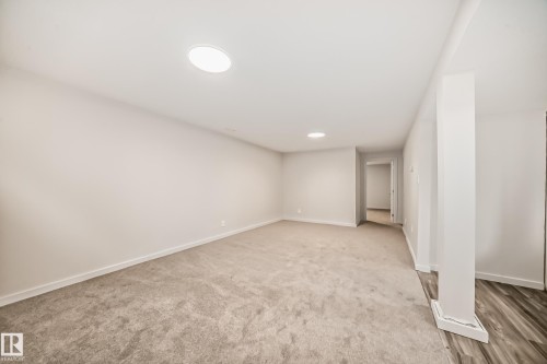 Spacious room featuring neutral carpeting, recessed lighting, and light-toned walls - 13124 83 Street, Edmonton, AB - Indoor Photo Showing Other Room