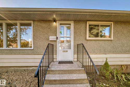 Concrete stairs with dark metal railings providing access to the front entry - 13124 83 Street, Edmonton, AB - Outdoor With Deck Patio Veranda With Exterior