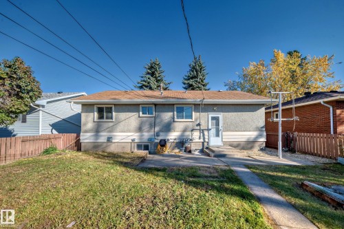 Rear exterior with stucco siding and a brown shingle roof - 13124 83 Street, Edmonton, AB - Outdoor