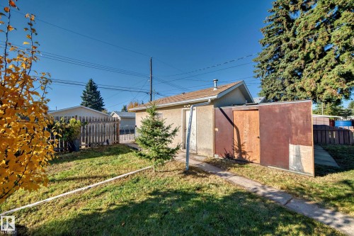 Rear property with a stucco-finished detached structure featuring a side entrance - 13124 83 Street, Edmonton, AB - Outdoor