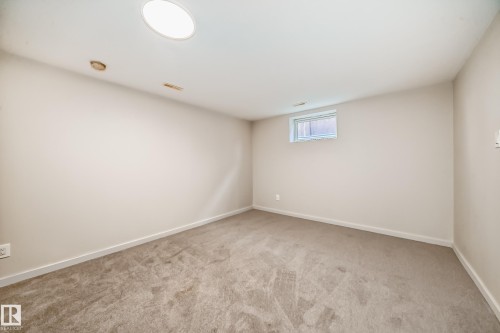 Spacious room featuring neutral carpeting and light-toned walls - 13124 83 Street, Edmonton, AB - Indoor Photo Showing Other Room