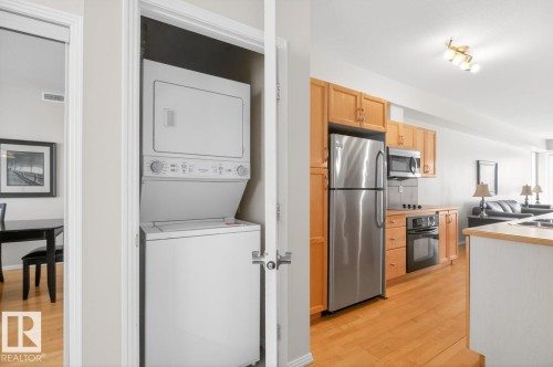 Full-sized stackable laundry unit within a dedicated closet - 614 10503 98 Avenue, Edmonton, AB - Indoor