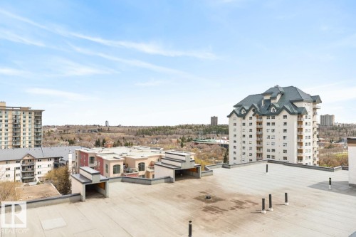 Expansive rooftop patio area with urban surroundings and distant tree lines - 614 10503 98 Avenue, Edmonton, AB - Outdoor