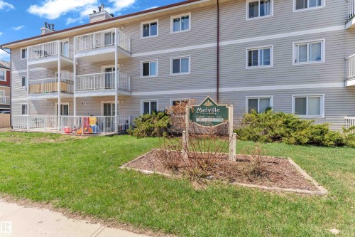 Multi-story building featuring light grey siding and multiple private balconies with white railings - 101 10136 160 Street Nw, Edmonton, AB - Outdoor