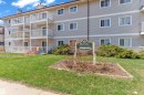 Multi-story building featuring light grey siding and multiple private balconies with white railings - 101 10136 160 Street Nw, Edmonton, AB  - Outdoor 