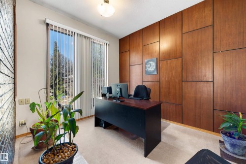 Room featuring a full wall of wood paneling and a large window with vertical blinds - 9602 85 Street, Edmonton, AB - Indoor Photo Showing Office