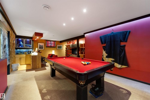 Recreational space featuring a red-felted billiard table, integrated wet bar with wood-finish cabinetry, recessed ceiling lighting, and accent wall lighting - 9602 85 Street, Edmonton, AB - Indoor Photo Showing Other Room