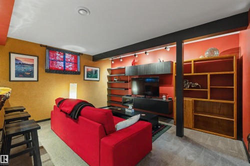 Recreational space featuring recessed lighting, track lighting, built-in shelving, a wood-finish bar, and textured wall finishes - 9602 85 Street, Edmonton, AB - Indoor