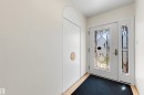 Entryway featuring a white door with decorative glass inserts, a coordinating sidelight, and wood-finish flooring - 9602 85 Street, Edmonton, AB  - Indoor Photo Showing Other Room 