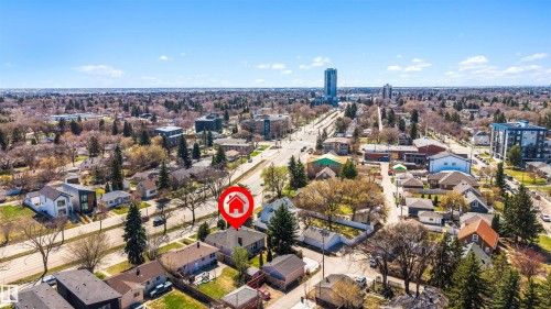 Aerial perspective showcasing a residential area with varied architectural styles, mature trees, and a clear sky backdrop - 9602 85 Street, Edmonton, AB - Outdoor With View
