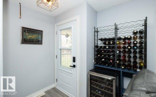 Dedicated beverage storage area featuring a built-in wine rack and a wine refrigerator - 27132A Twp Rd 632, Rural Westlock County, AB - Indoor Photo Showing Other Room
