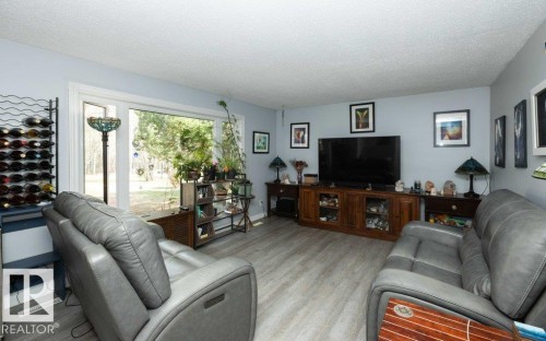 Living area featuring light wood-finish flooring and a large picture window - 27132A Twp Rd 632, Rural Westlock County, AB - Indoor Photo Showing Living Room