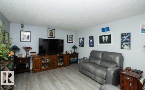 Living space featuring light blue wall paint and wood-finish flooring - 27132A Twp Rd 632, Rural Westlock County, AB - Indoor Photo Showing Living Room