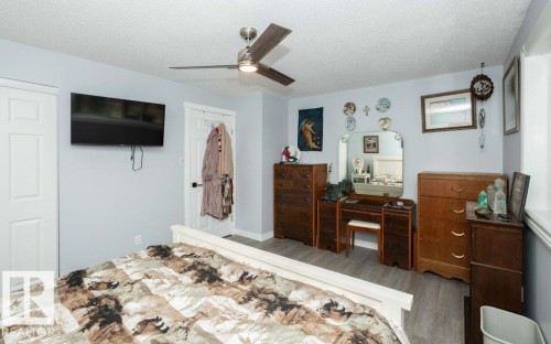 Spacious room featuring wood-finish flooring, a contemporary ceiling fan, and light blue wall tones - 27132A Twp Rd 632, Rural Westlock County, AB - Indoor