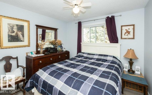 Bedroom featuring light blue walls, a white ceiling fan, and wood-finish flooring - 27132A Twp Rd 632, Rural Westlock County, AB - Indoor Photo Showing Bedroom