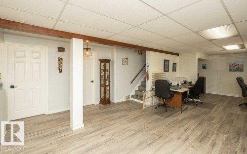 Finished lower level featuring wood-finish flooring, drop ceiling, and recessed lighting - 27132A Twp Rd 632, Rural Westlock County, AB - Indoor
