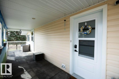 Covered front porch featuring textured floor tiles - 27132A Twp Rd 632, Rural Westlock County, AB - Outdoor With Deck Patio Veranda With Exterior