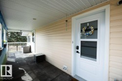 Covered front porch featuring textured floor tiles - 