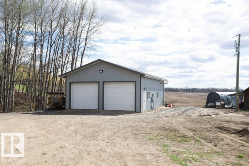 Detached barn structure featuring light gray siding and a dark gray gable roof - 27132A Twp Rd 632, Rural Westlock County, AB - Outdoor