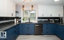 Kitchen featuring white upper cabinetry, blue lower cabinetry, and black hardware - 27132A Twp Rd 632, Rural Westlock County, AB  - Indoor Photo Showing Kitchen 