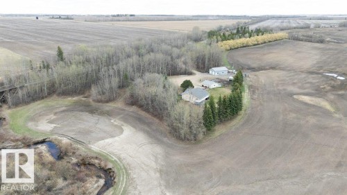 Rural property with a residential structure, detached outbuilding, and extensive surrounding agricultural fields - 27132A Twp Rd 632, Rural Westlock County, AB - Outdoor With View