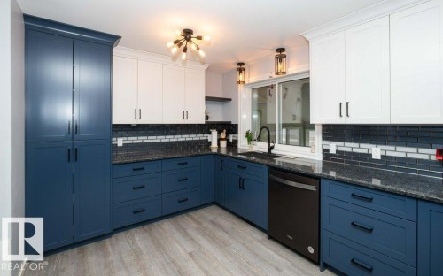 Kitchen featuring two-tone cabinetry with white upper cabinets and navy lower cabinets - 27132A Twp Rd 632, Rural Westlock County, AB - Indoor Photo Showing Kitchen