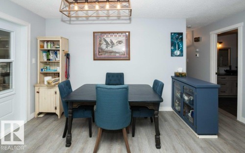 Light gray wood-finish flooring complements the neutral wall color - 27132A Twp Rd 632, Rural Westlock County, AB - Indoor Photo Showing Dining Room