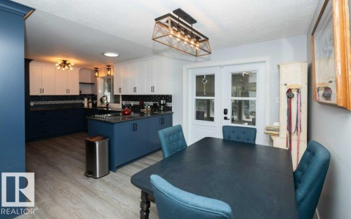 Bright dining space with wood-finish flooring and direct access to the kitchen - 27132A Twp Rd 632, Rural Westlock County, AB - Indoor