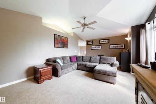 Living area featuring vaulted ceilings, a ceiling fan, and carpeted floors - 4 Windrose Drive, Leduc, AB - Indoor Photo Showing Living Room