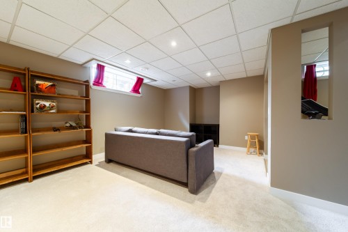 This interior space features light-colored carpeting, recessed lighting, and a drop ceiling - 4 Windrose Drive, Leduc, AB - Indoor Photo Showing Basement
