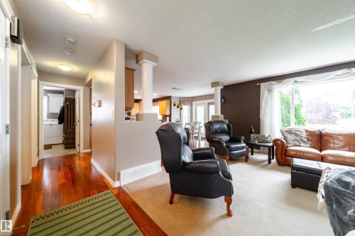 The property features a spacious living area with large windows, offering natural light and views of the outdoors - 4 Windrose Drive, Leduc, AB - Indoor Photo Showing Living Room