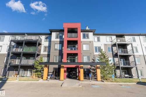 Multi-story building featuring a red and gray facade with white accents - 221 344 Windermere Road, Edmonton, AB - Outdoor With Balcony With Facade