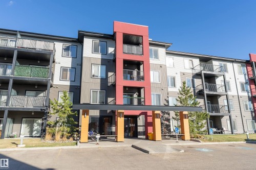 Multi-story residential building featuring a prominent red accent facade and multiple balconies - 221 344 Windermere Road, Edmonton, AB - Outdoor With Balcony With Facade