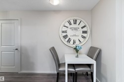 Neutral-toned wall space featuring a flush-mount ceiling light and wood-finish flooring - 