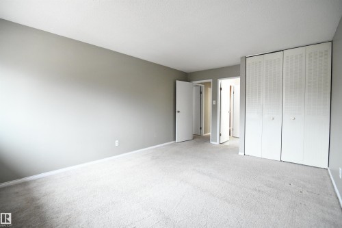 The master bedroom is cavernous and easily supports king sized furniture.  Ample floor space and double, floor to ceiling closets give provide great storage.  A second door from the master also serves the large 4 piece bathroom.  Great privacy - 6706 36A Avenue, Edmonton, AB - Indoor Photo Showing Other Room