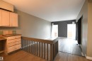 Floor to ceiling windows at the far end of the living room let in great natural light, and are a nice touch.  Patio doors lead from the living room to the private rear deck and yard as well - 6706 36A Avenue, Edmonton, AB  - Indoor Photo Showing Other Room 