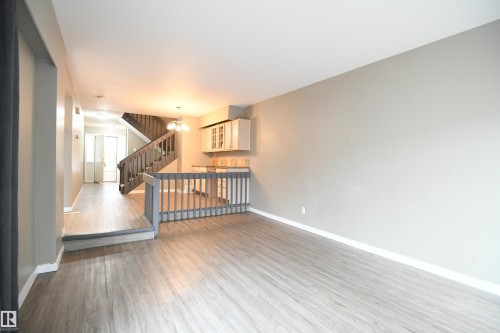 The open layout really does provide some great options for furniture placement, and makes for a great family and entertaining space.  The patio doors open on to the private rear deck and yard - 6706 36A Avenue, Edmonton, AB - Indoor Photo Showing Other Room