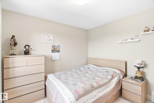 Bedroom with neutral wall paint and light-colored carpeting - 6864 Evans Wynd, Edmonton, AB - Indoor Photo Showing Bedroom