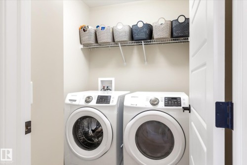Dedicated laundry area featuring a wire rack shelving unit - 6864 Evans Wynd, Edmonton, AB - Indoor Photo Showing Laundry Room