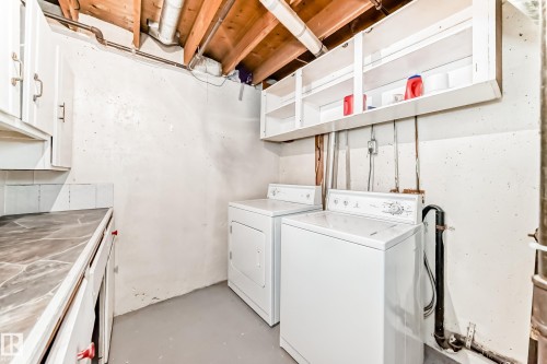 Utility area featuring a top-load washer and front-load dryer, exposed wood ceiling joists, white wall cabinetry, and a countertop with white base cabinets - 6117 120 Avenue, Edmonton, AB - Indoor Photo Showing Laundry Room