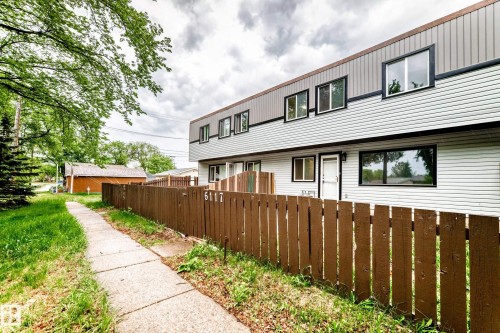 Two-story residential building featuring light grey siding and a brown-toned upper level - 6117 120 Avenue, Edmonton, AB - Outdoor