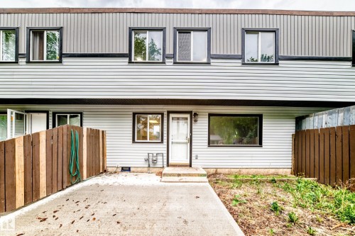 Two-story facade with light-colored horizontal siding and dark trim accents - 6117 120 Avenue, Edmonton, AB - Outdoor With Exterior