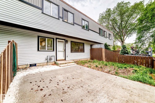 Multi-story exterior with light-toned horizontal siding and dark trim - 6117 120 Avenue, Edmonton, AB - Outdoor